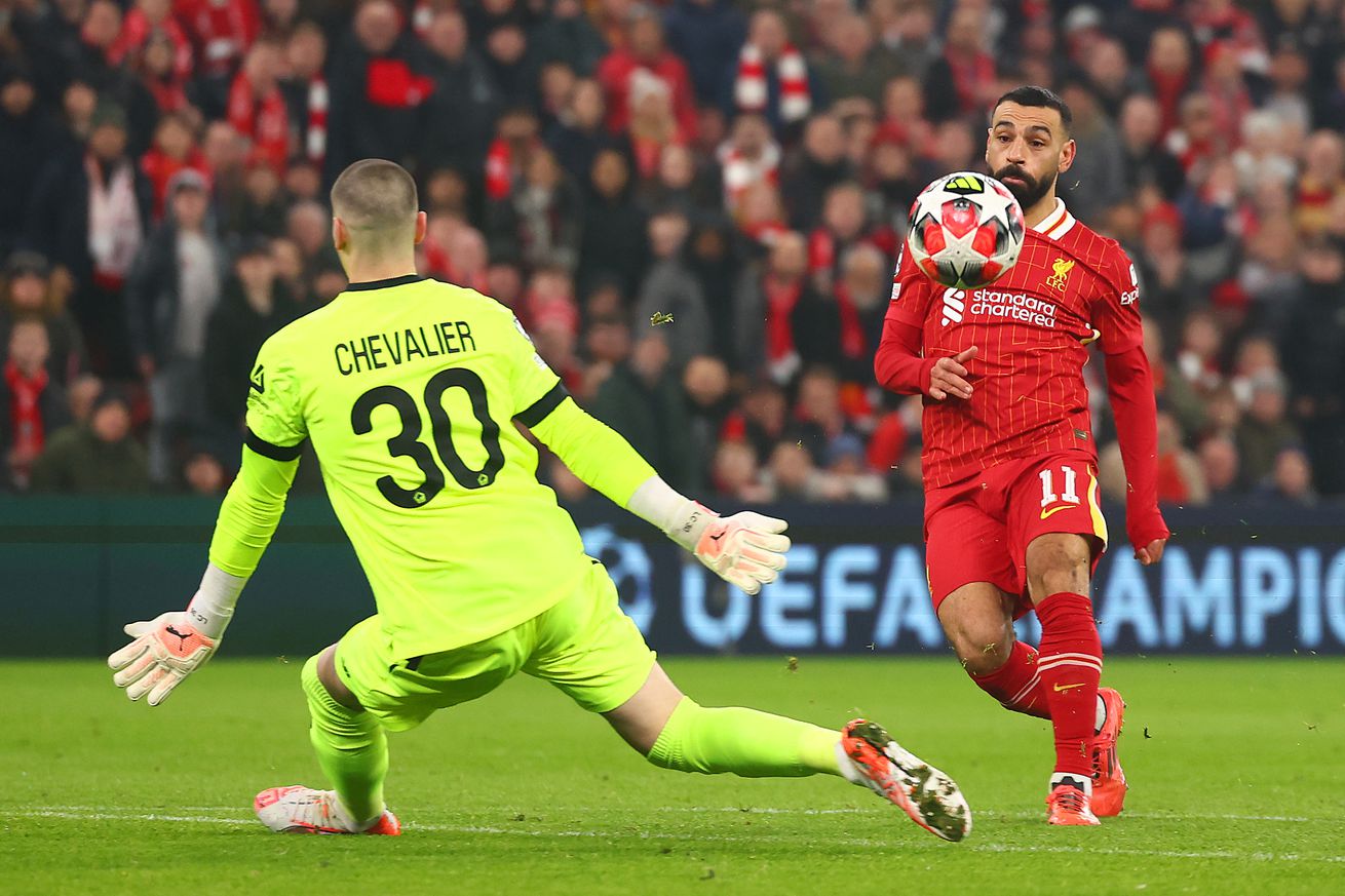 Mohamed Salah of Liverpool scores the opening goal past Lucas Chevalier of Lille during the UEFA Champions League 2024/25 League Phase MD7 match between Liverpool FC and LOSC Lille at Anfield on January 21, 2025 in Liverpool, England.