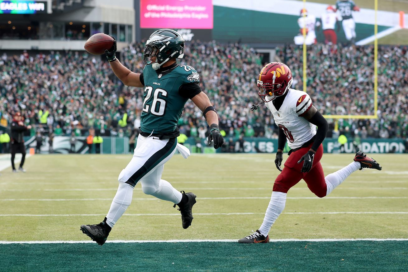 Saquon Barkley #26 of the Philadelphia Eagles scores a 4 yard touchdown against the Washington Commanders during the first quarter in the NFC Championship Game at Lincoln Financial Field on January 26, 2025 in Philadelphia, Pennsylvania.