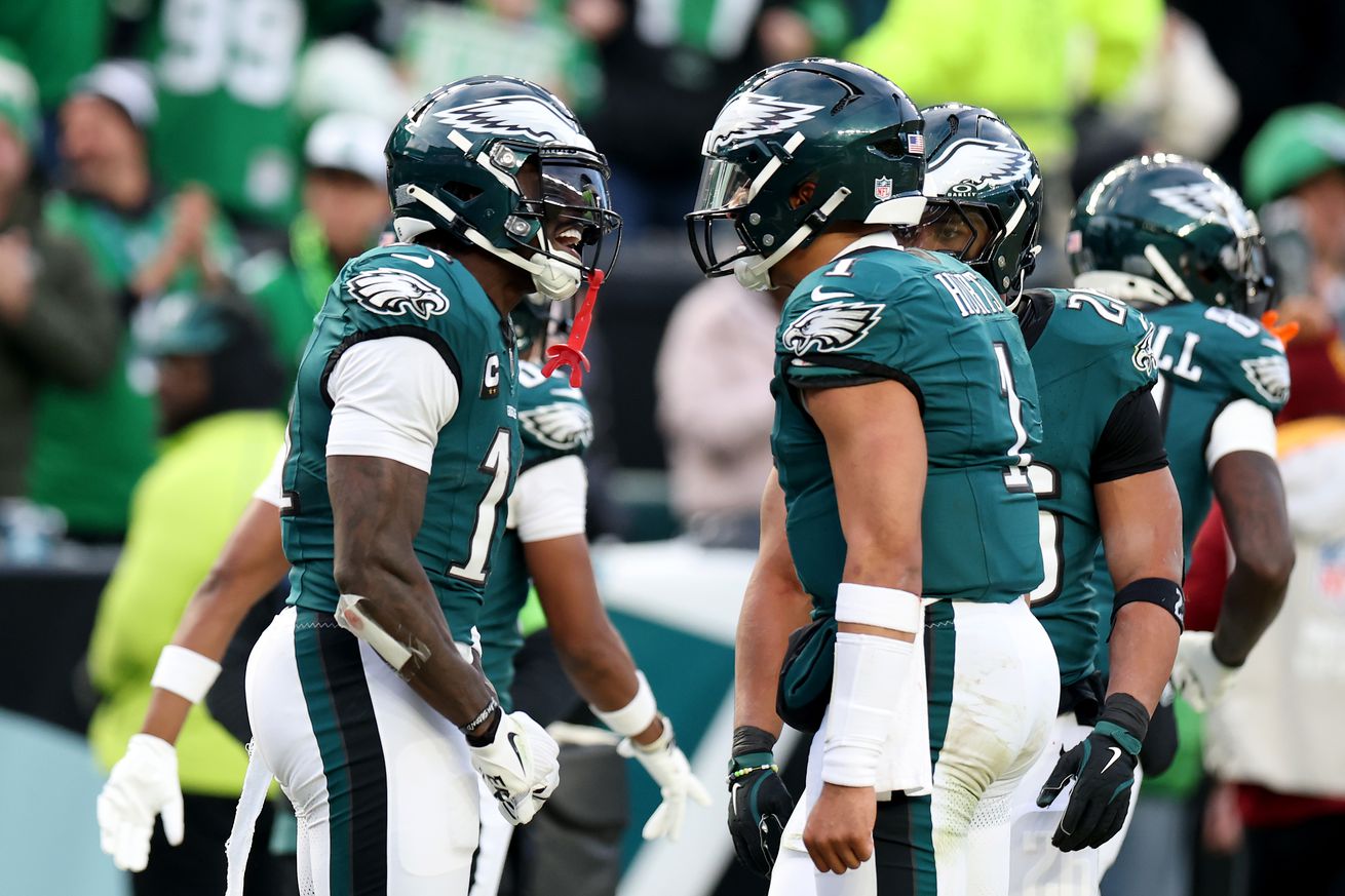 A.J. Brown #11 of the Philadelphia Eagles celebrates his touchdown with teammates Saquon Barkley #26 and Jalen Hurts #1 while playing the Washington Commanders during the second quarter in the NFC Championship Game at Lincoln Financial Field on January 26, 2025 in Philadelphia, Pennsylvania.