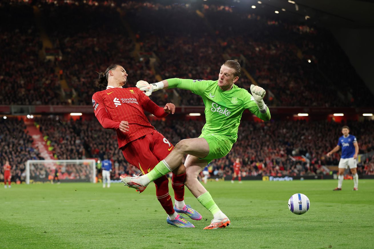 Darwin Nunez of Liverpool is challenged by Jordan Pickford of Everton during the Premier League match between Liverpool FC and Everton FC at Anfield on April 02, 2025 in Liverpool, England.