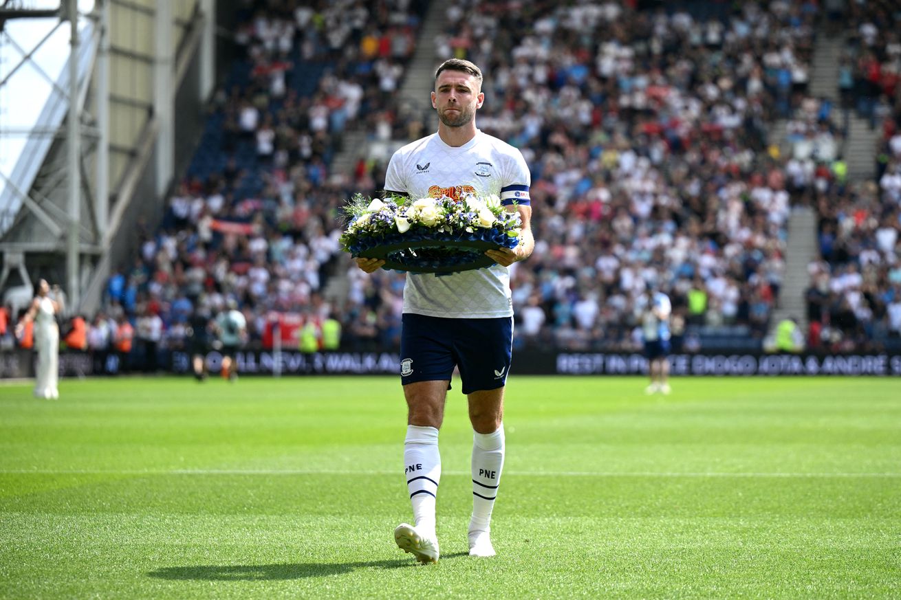Preston North End captain Benjamin Whiteman lays a wreath in front of the away end before kick-off.